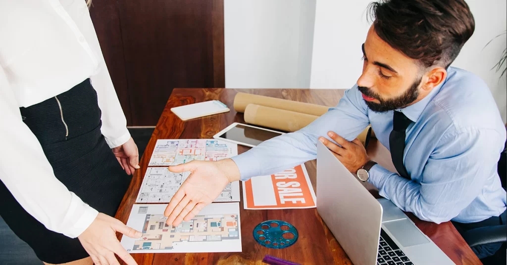 A airbnb rental agency shaking a person hand 